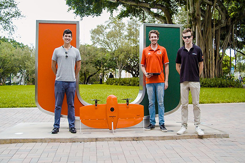 This is a photo of the three University of Miami alumni who founded Precision Ecology. They are standing in front of the "U" statue at the University of Miami Coral Gables campus.